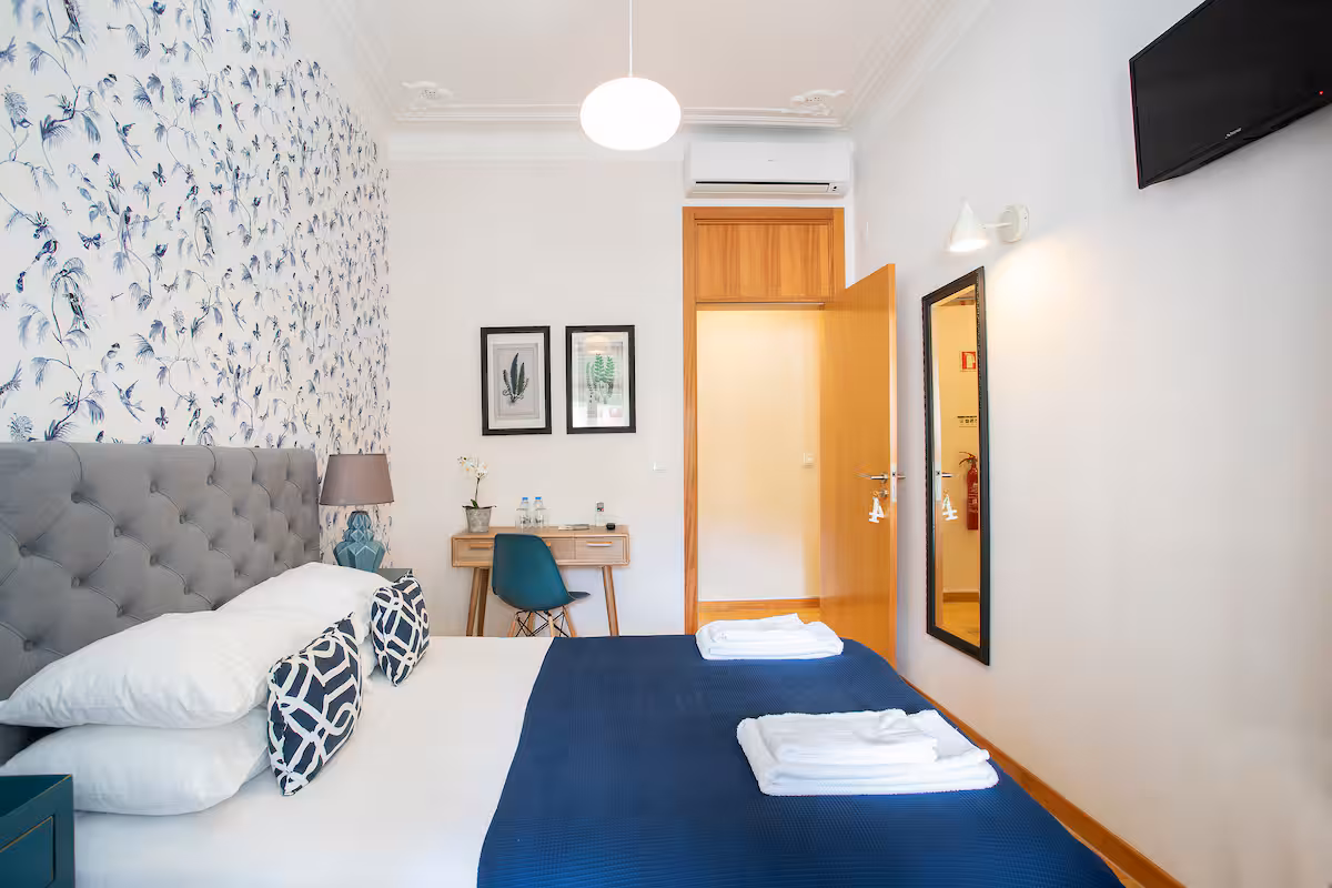 Double room with blue bird wallpaper